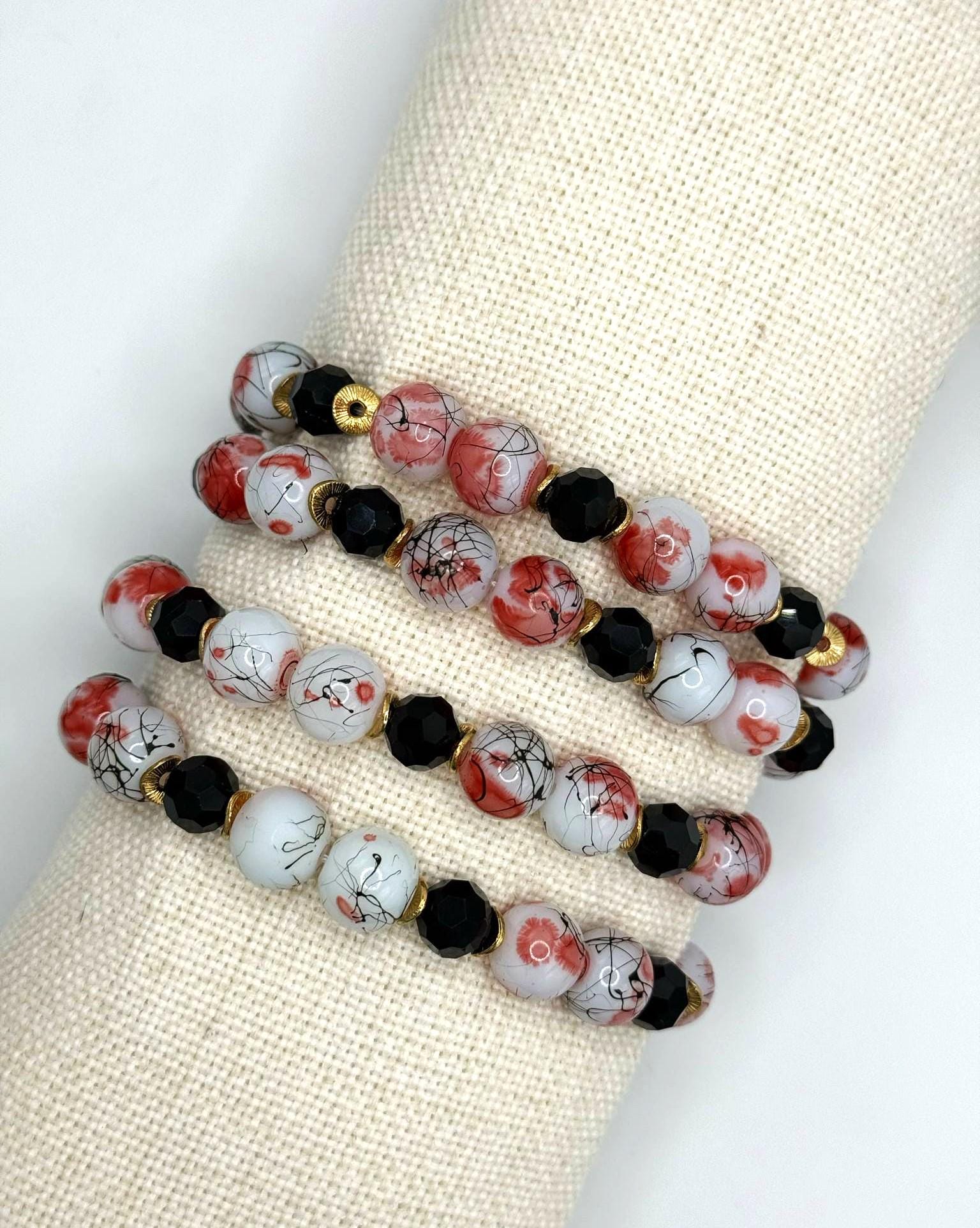 Red and Black Paint Splatter Glass Bead and Gold AccentBracelet